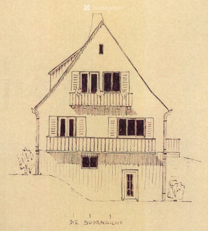 Two-story house with a pitched roof, multiple windows, and balconies on both floors.