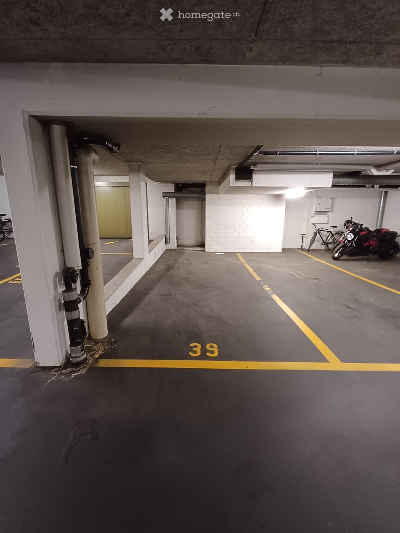 {"type": "Parking place", "objects": ["motorcycle", "bicycle"], "description": "Underground parking space with marked parking spots, a motorcycle, and a bicycle visible.", "localized_descriptions": {"EN": "Underground parking space with marked parking spo