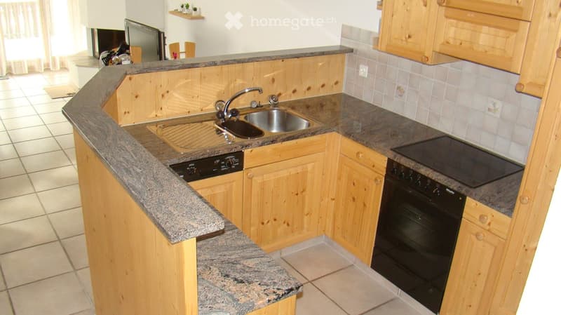 wooden cabinets, granite countertops, stainless steel sink, dishwasher, black oven, tiled floor