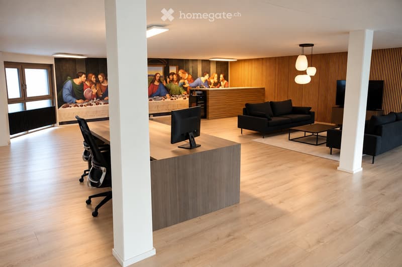 Modern living room with light wooden flooring, two black sofas, a coffee table, a screen, and a chair near a table.