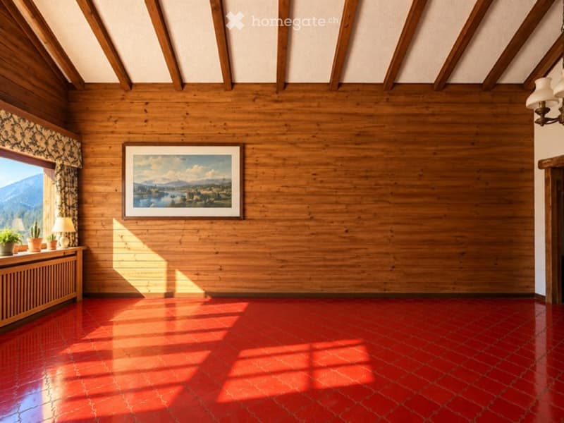 Empty room with wooden walls, red tiled floor, large window with view, small table with plants and lamp, framed picture on wall.