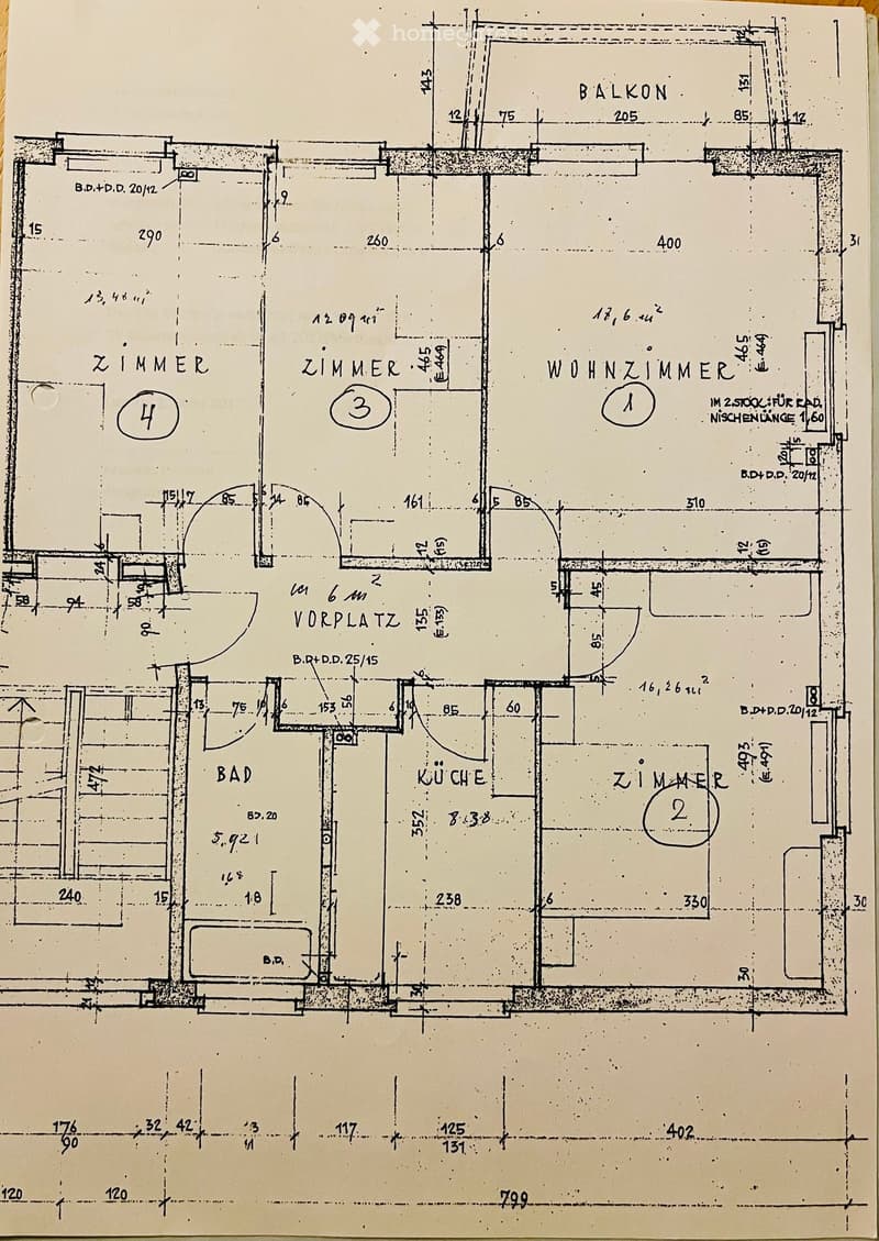 Floor plan of a two-story apartment with labeled rooms: Wohnzimmer (living room), Zimmer (bedroom), Bad (bathroom), Küche (kitchen), and Balkon (balcony).