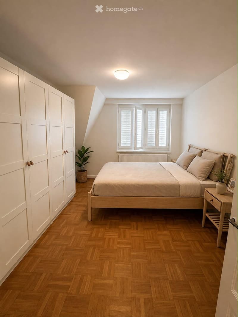 Cozy attic bedroom with wooden herringbone flooring, large window with shutters, bed with beige bedding, nightstand with plant, and built-in wardrobe.