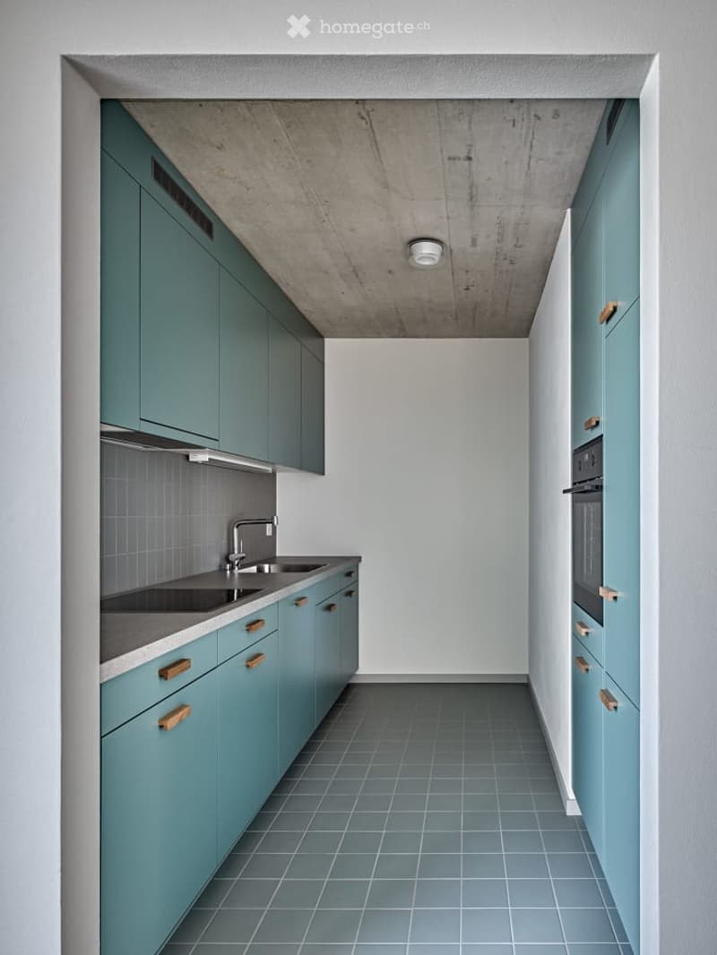 modern kitchen with teal cabinets, double sinks, oven, dishwasher, tiled floor