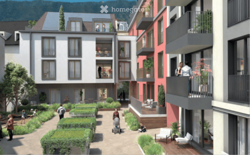 A modern residential complex with multiple apartment buildings, balconies, and a landscaped courtyard area with greenery and seating.