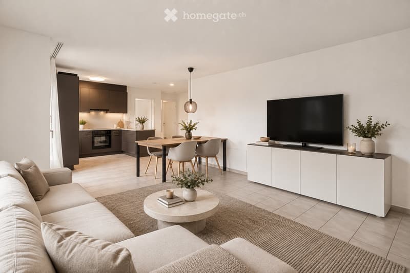 Modern open-plan living and dining area with a sofa, coffee table, dining table with chairs, and a television on a cabinet. The kitchen features dark cabinets and stainless steel appliances.