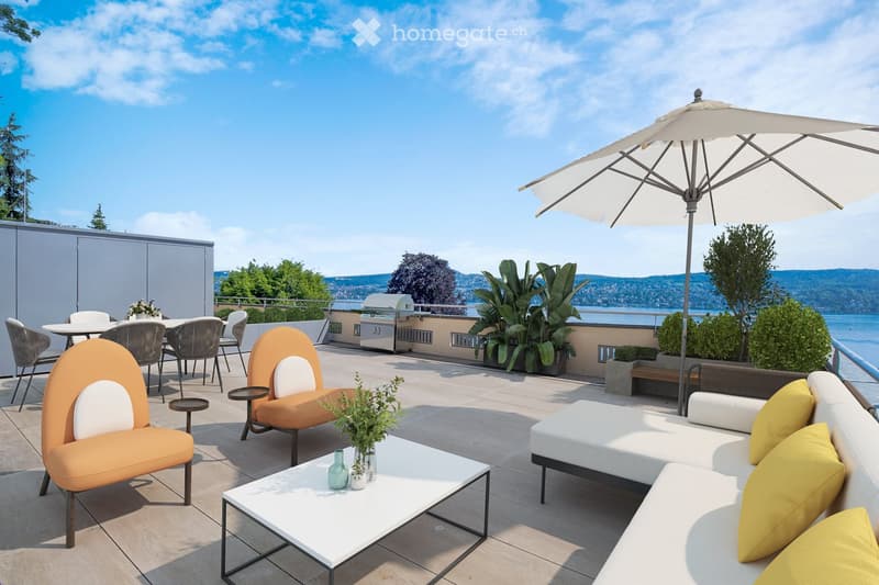 A modern rooftop terrace with a view of the water, featuring a white sofa with yellow cushions, orange chairs, a white coffee table, a dining area with chairs and a table, a large umbrella, and potted plants.