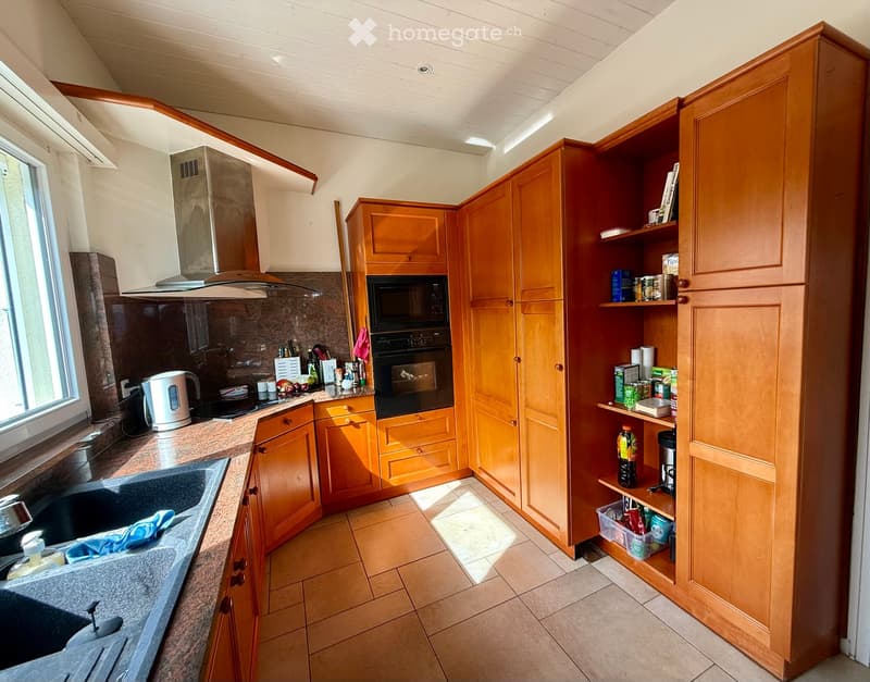 {"type": "Kitchen", "objects": ["sink", "oven", "microwave", "cabinets", "kitchen island", "faucet", "cupboard", "bottle", "cup", "bottle", "oven", "microwave", "cupboard", "cupboard", "cupboard", "cupboard", "cupboard", "cupboard", "cupboard", "cupboard"
