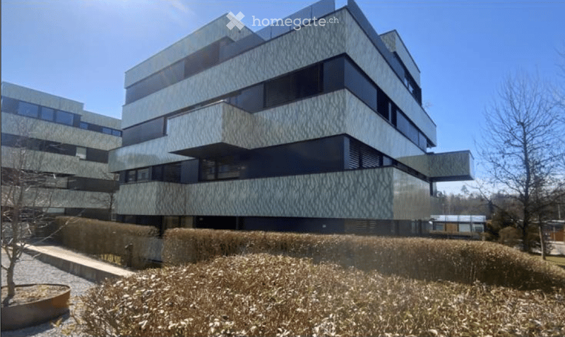 Modern multi-story building with a sleek, contemporary design featuring large windows and geometric patterns on the facade.