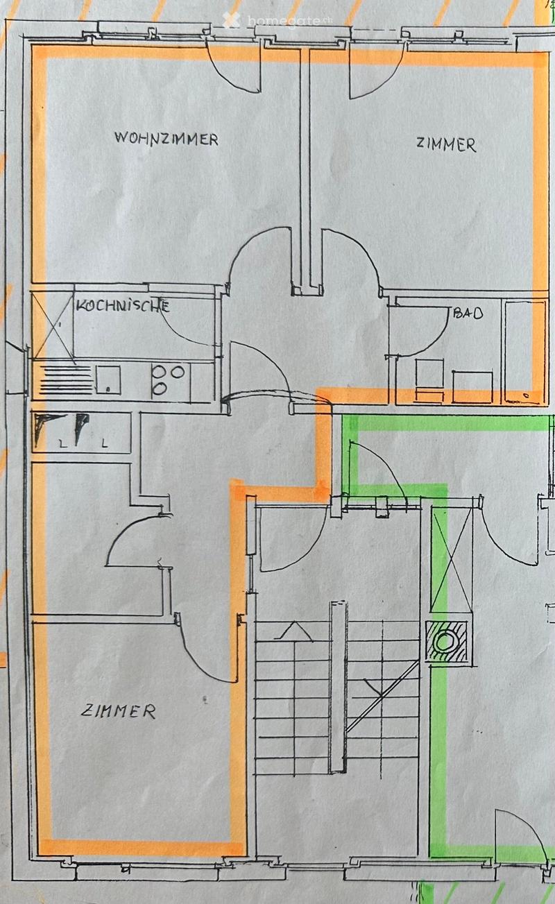 Floor plan showing a living room, kitchen, two bedrooms, and a bathroom. Includes a staircase leading to another level.