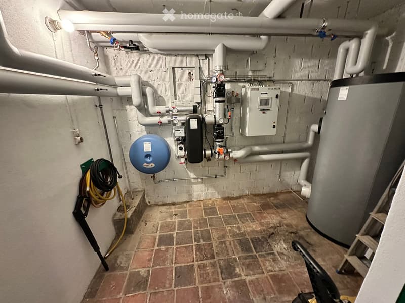 Basement, tiled floor, large tank, water pipes, ladder, hoses