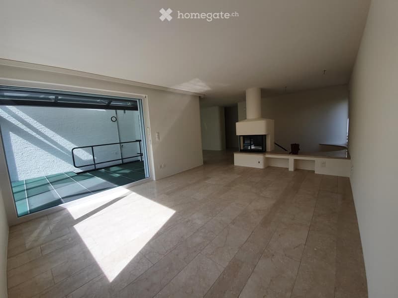 Empty room with tiled floor, large window, fireplace, and bench seating area.