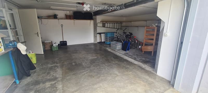 {"visible_features": ["Garage"], "type": "Garage", "objects": [], "description": "Clean, organized garage with concrete floor, shelving units, bicycles, and various stored items including ladders, tools, and crates.", "localized_descriptions": {"EN": "Cle