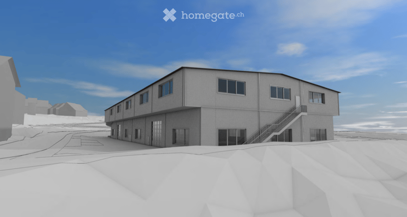 A modern, industrial-style building with a flat roof and large windows, situated in a snowy landscape under a clear blue sky.