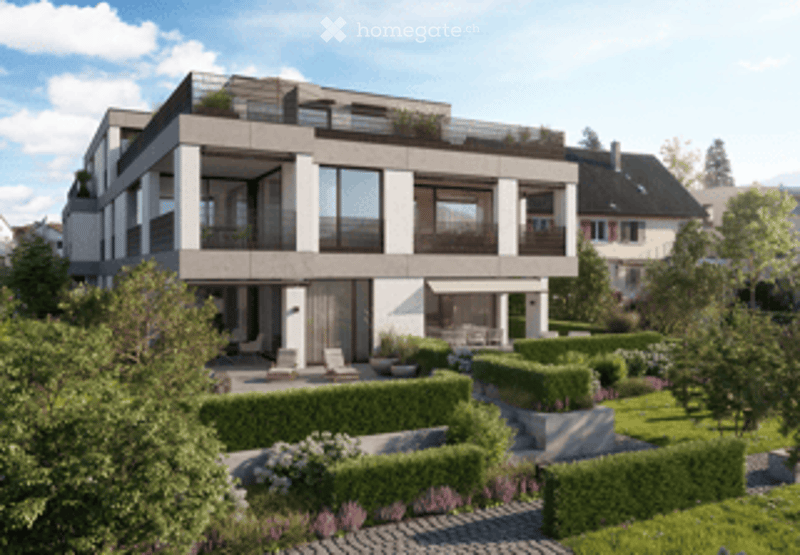 Modern multi-story residential building with large windows, balconies, and a landscaped garden area with trimmed hedges, flowers, and outdoor seating.