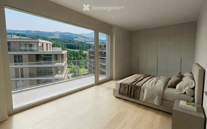 Modern bedroom with large windows offering a scenic mountain view, featuring a bed with pillows and a blanket, a nightstand, and built-in wardrobes.