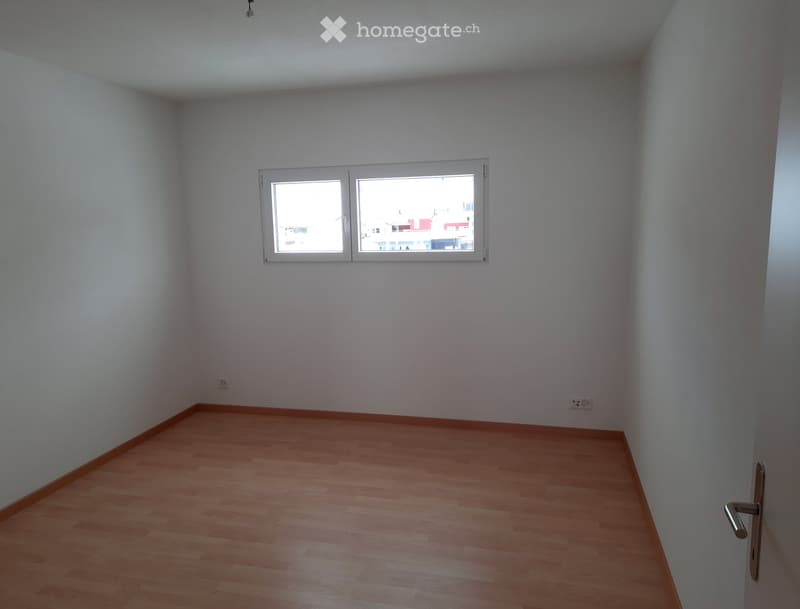 empty room, white walls, wooden floor, window, power outlets