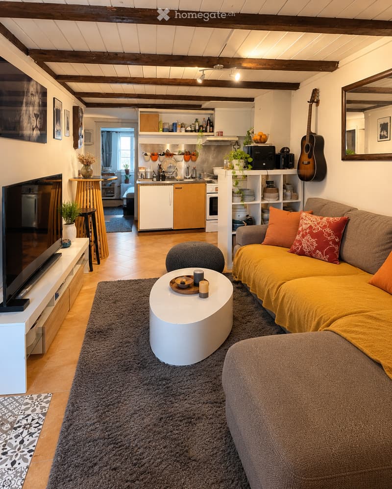 Cozy living room with a yellow sofa, white coffee table, grey rug, and a small kitchen area visible in the background. Features wooden beams on the ceiling, a guitar on the wall, and various decorative items.