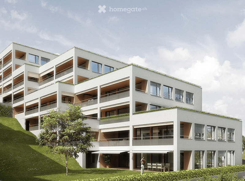 Modern multi-story residential building with white facade, large windows, balconies, and green rooftop.