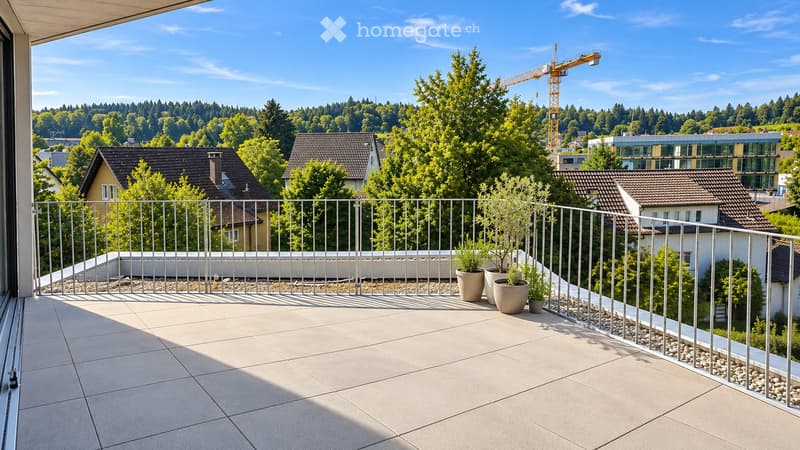 Balcony with tiled floor, metal railing, and potted plants, overlooking a suburban area with houses and trees.