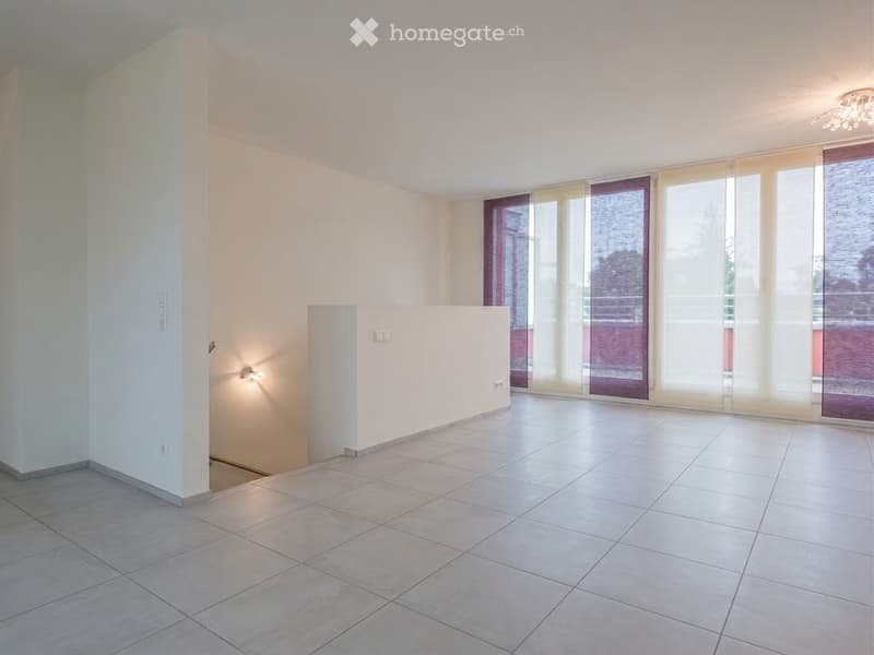 Empty room with tiled floor, white walls, large windows with blinds, and recessed lighting.