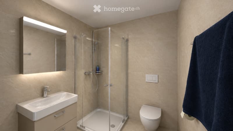 Modern bathroom with beige tiles, a glass-enclosed shower, a white sink with a mirror, and a toilet.
