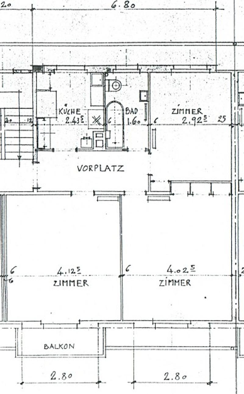 Floor plan showing a kitchen, bathroom, living area, two bedrooms, and a balcony.