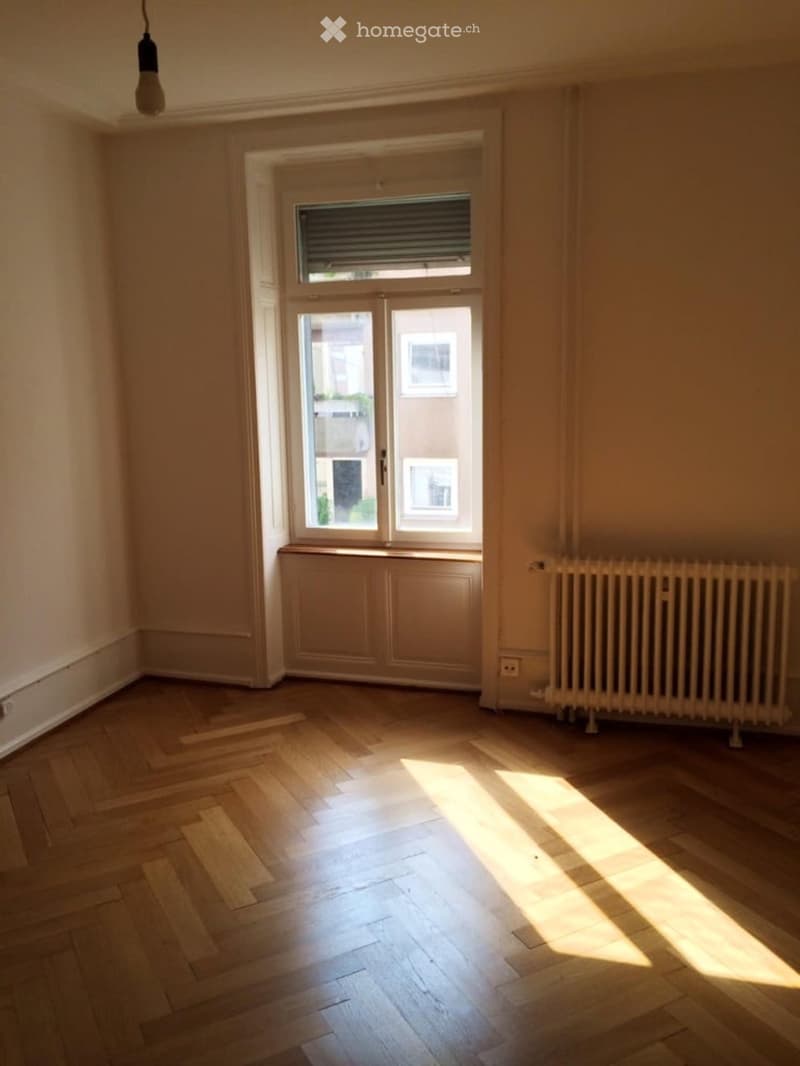 empty room, wooden parquet flooring, large window, white walls, white radiator, wooden window sill
