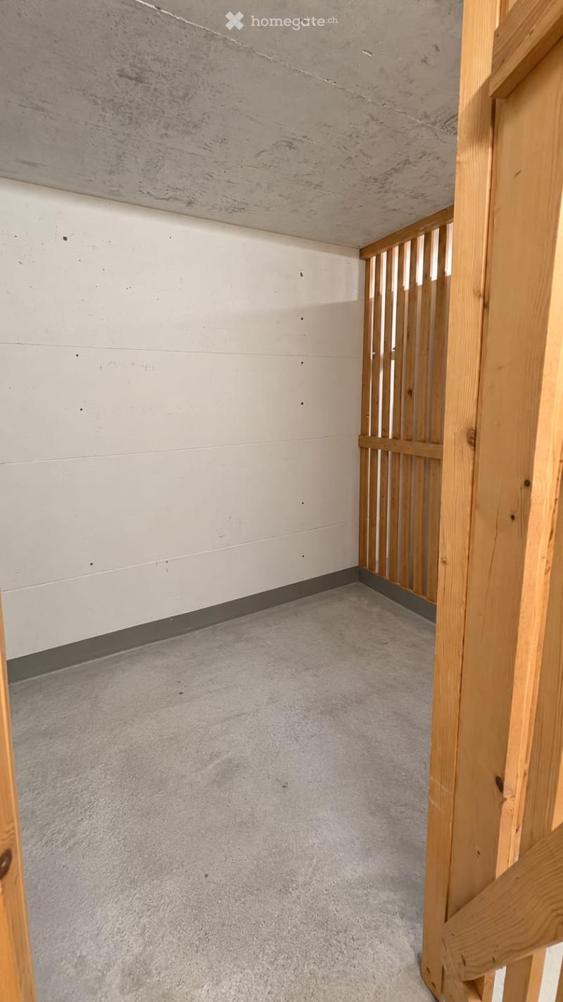 Empty room with bare walls, wooden framing, and a concrete floor. No furniture or equipment present.