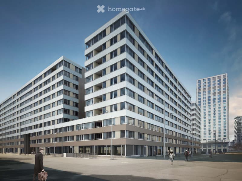 Modern multi-story apartment building with clean lines, large windows, and a contemporary design. The building features a mix of glass and concrete elements, with a spacious plaza in front.