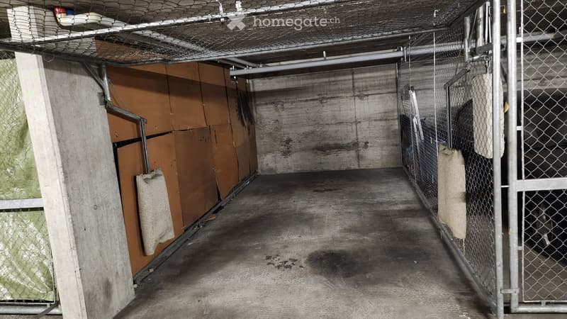 {"type": "Garage", "objects": [], "description": "Underground garage with concrete walls, metal fencing, and storage boxes. The space appears to be used for storage with no vehicles present.", "localized_descriptions": {"EN": "Underground garage with conc
