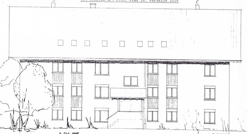 Floor plan of a multi-story building with multiple windows and a staircase leading to an upper level.