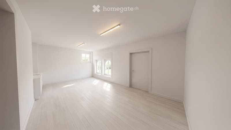 Empty room with light wooden flooring, white walls, and large windows allowing natural light. No furniture or equipment is present.