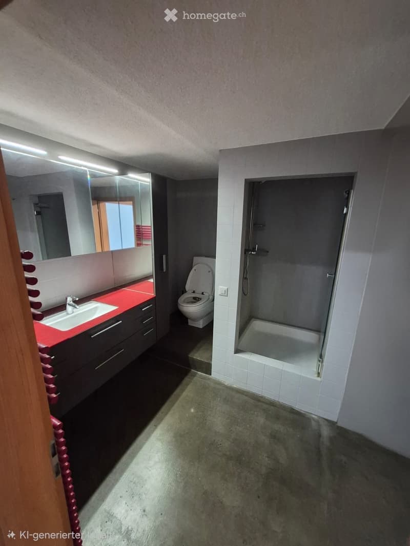 Modern bathroom with a red countertop sink, white toilet, glass-enclosed shower, and large mirror.