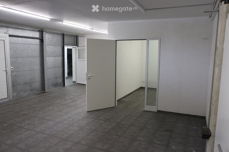 Empty room with tiled floor, white walls, and multiple doors leading to other spaces. No furniture or equipment visible.