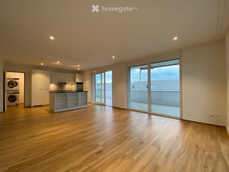 Open kitchen with wooden floors, granite countertops, glass sliding doors, built-in appliances
