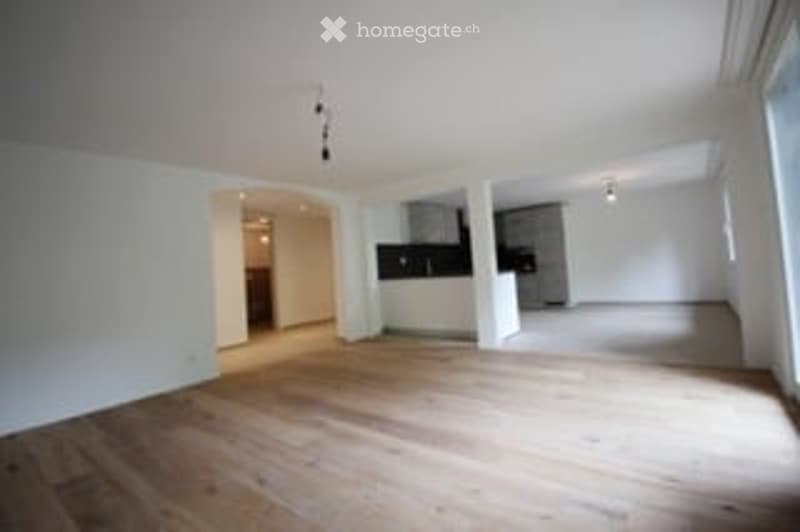 Empty room with wooden flooring, white walls, and recessed lighting. No furniture or equipment present.