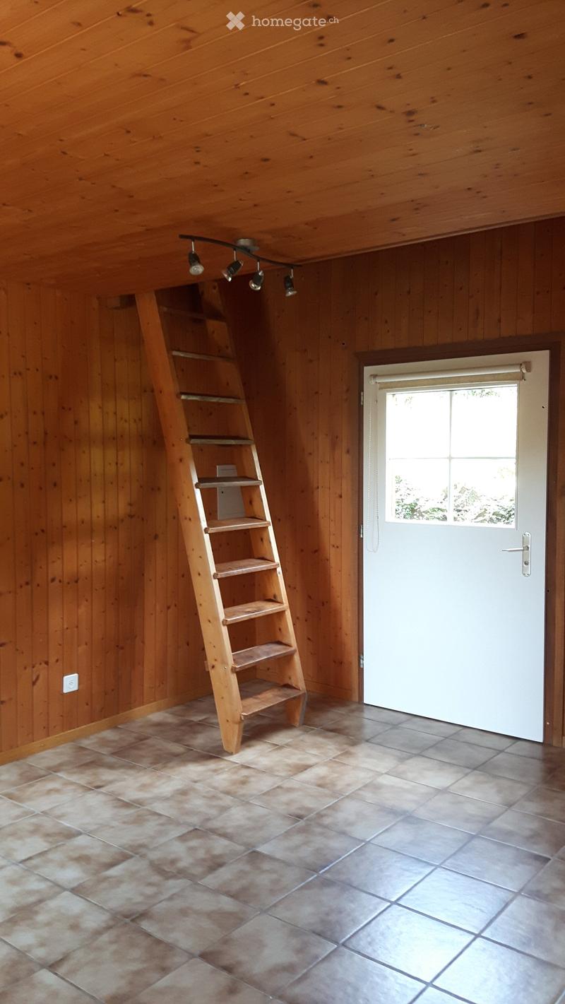 empty room, wooden walls, wooden ladder, white door, tiled floor