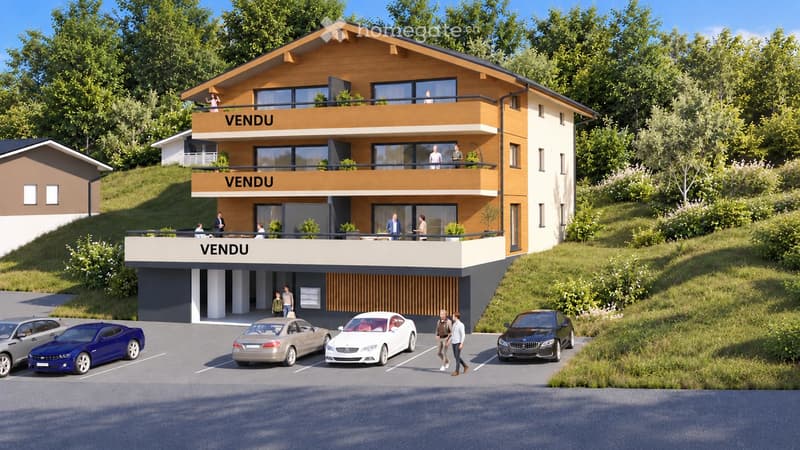Modern two-story house with balconies, large windows, and a parking area with several cars.