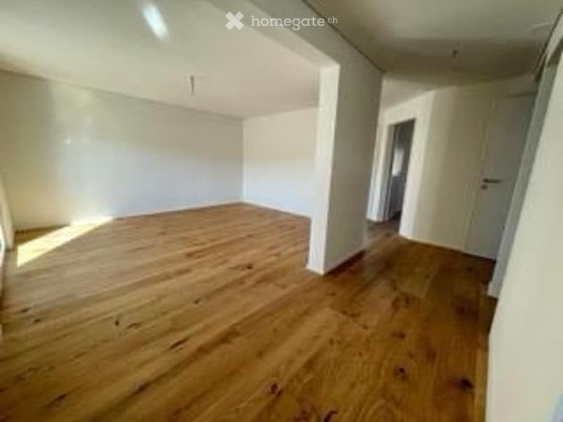 Completely empty room with white walls and wooden floor. No furniture or equipment.