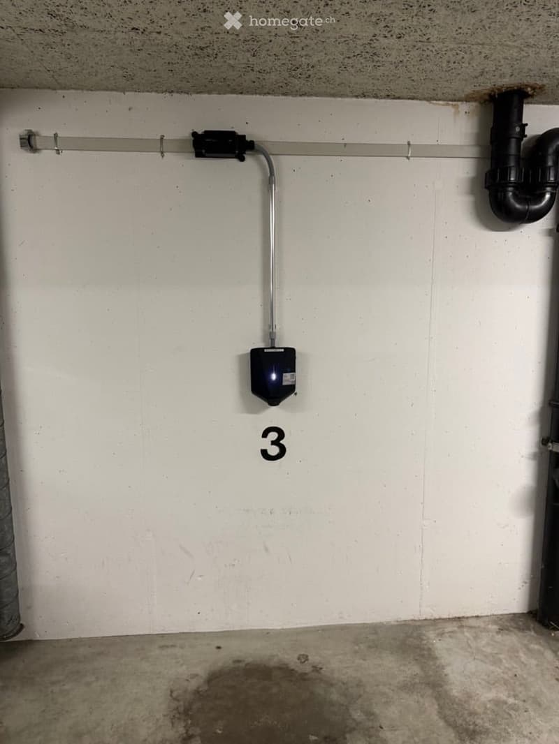 Unfurnished Room. Empty basement or utility room with concrete floor, white walls, and a numbered section marked '3'. Includes a small black device and visible pipes.
