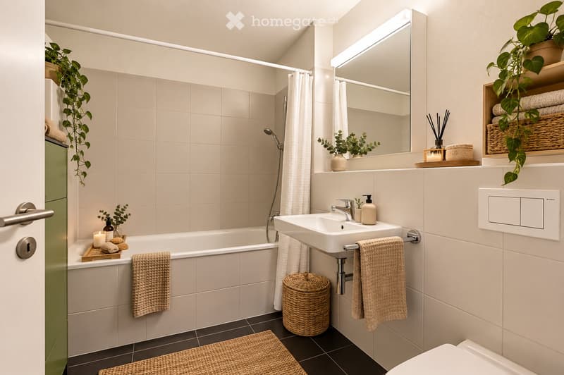 Modern bathroom with a bathtub, sink, toilet, and large mirror. Features include wicker baskets, towels, plants, and a candle on the bathtub ledge.