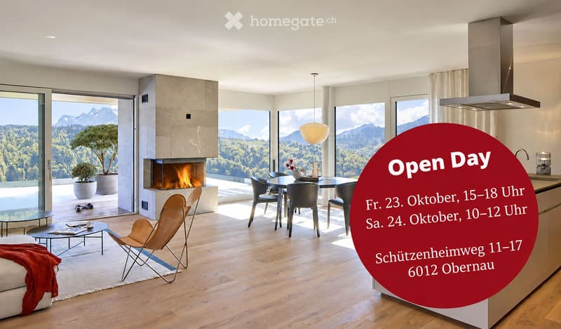 Modern open-plan living and dining area with large windows offering a scenic mountain view, fireplace, sofa, coffee table, dining table, and kitchen island.