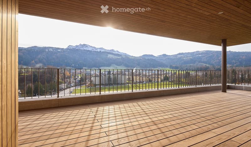 wooden deck with metal railings, panoramic mountain view