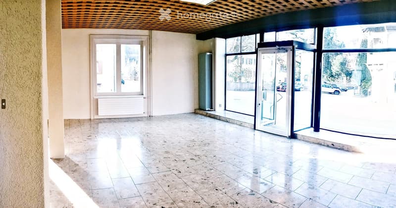 Empty room, large windows, tiled floor, radiator, automatic door