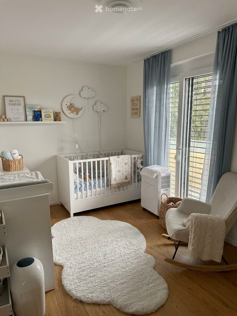 Cozy nursery with a white crib, rocking chair, round white rug, wicker baskets, and decorative wall art.