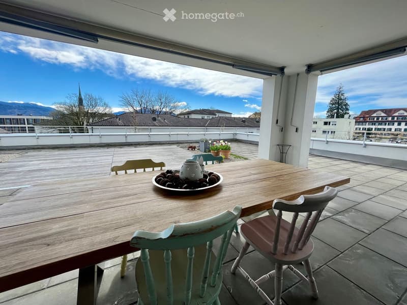 wooden table with 4 chairs, balcony with view to mountains