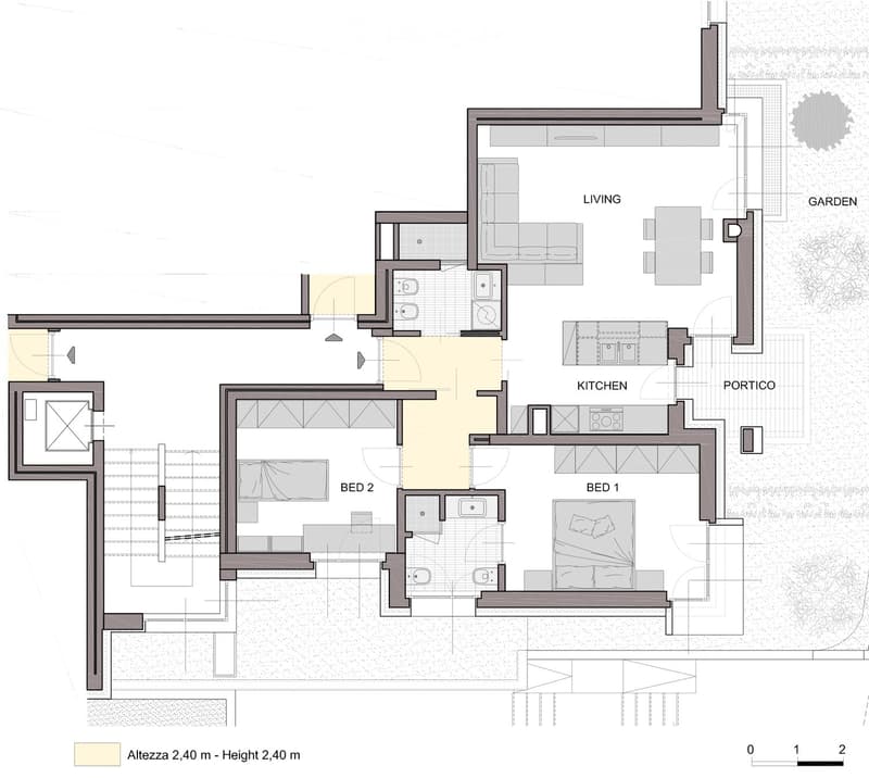 Floor plan of a house with two bedrooms, a living area, a kitchen, a portico, and a garden.
