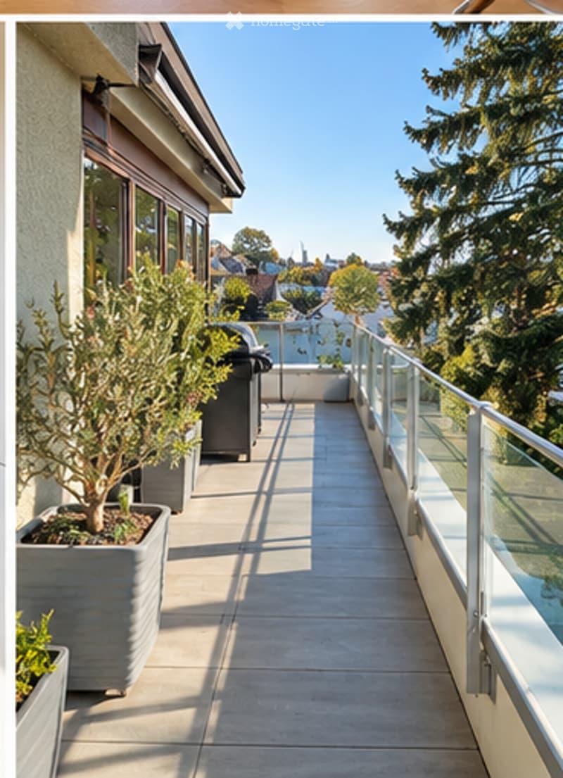 Spacious balcony with modern glass railing, potted plants, and a view of the city and surrounding greenery.