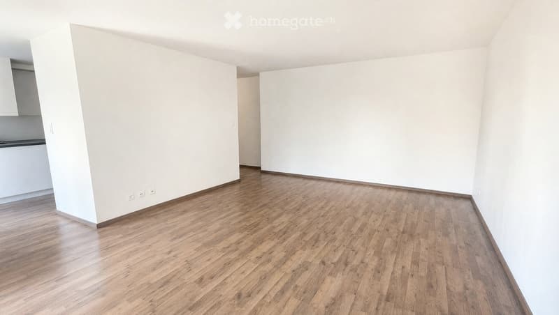 Empty room with light wooden flooring and white walls. No furniture or equipment present.